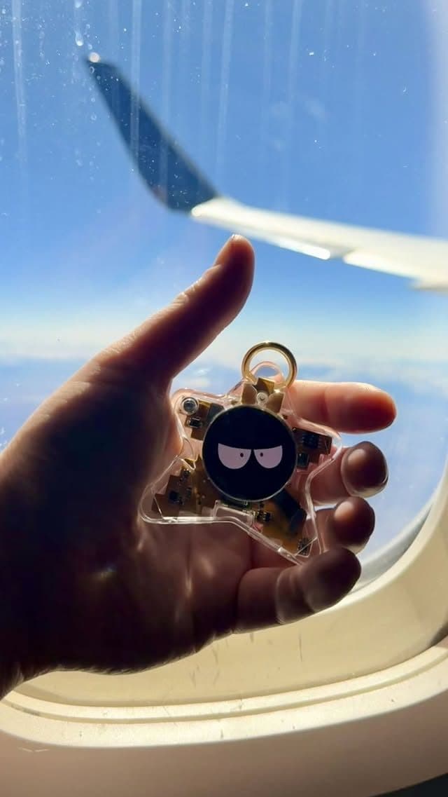 Real Oneira product held up to an airplane window mid-flight — unretouched photo